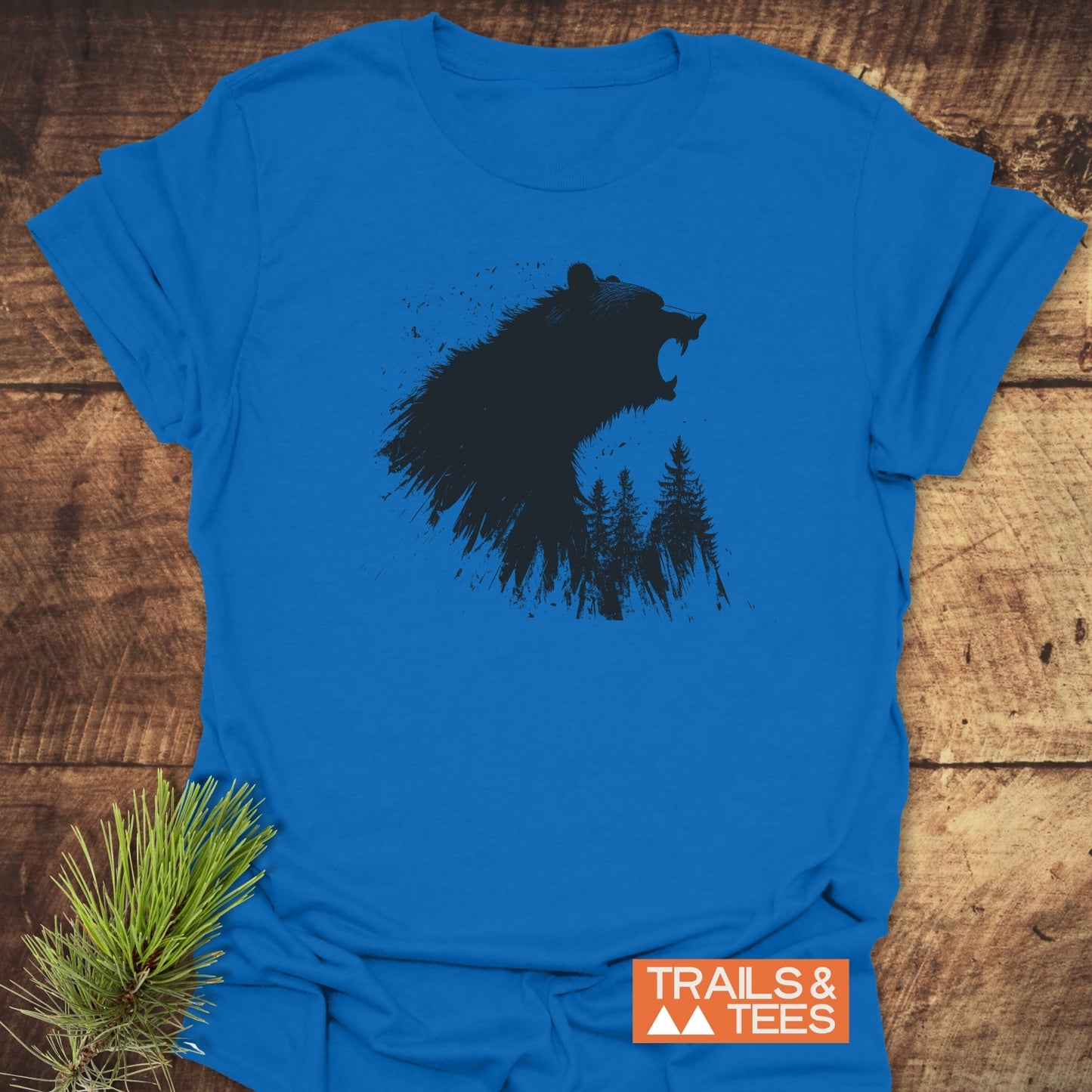 Roaring Bear Forest T-Shirt: Bright blue tee with a black roaring bear and pine tree graphic, crafted from soft, lightweight ring-spun cotton for comfort and durability.