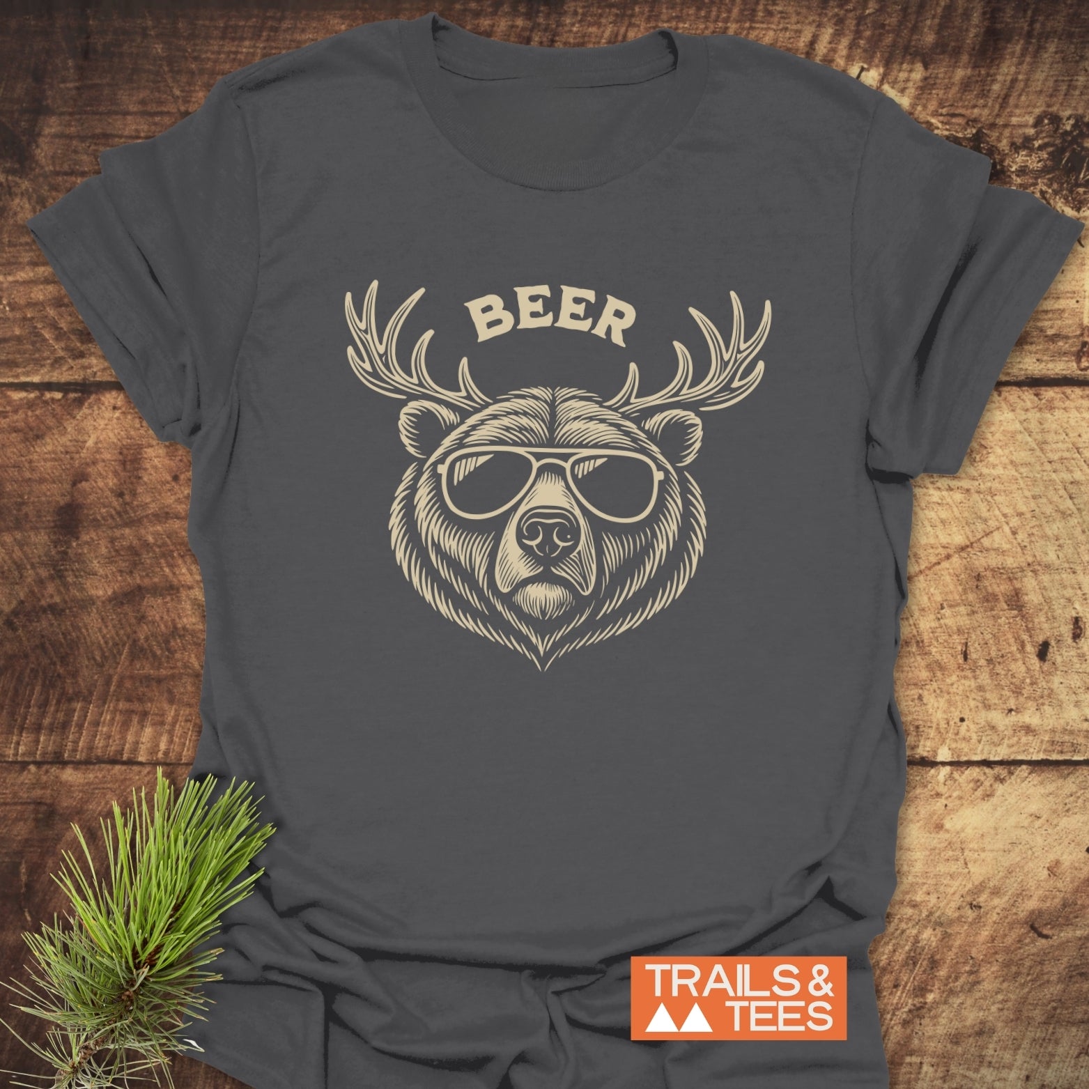 Beer Funny T-Shirt featuring a bear with antlers and sunglasses graphic. Made of soft cotton, it offers comfort and durability for outdoor enthusiasts.