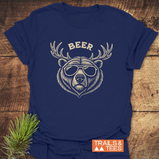 Beer Funny T-Shirt featuring a bear with sunglasses and antlers graphic. Made from soft cotton, perfect for outdoor adventures. Trails & Tees logo visible.