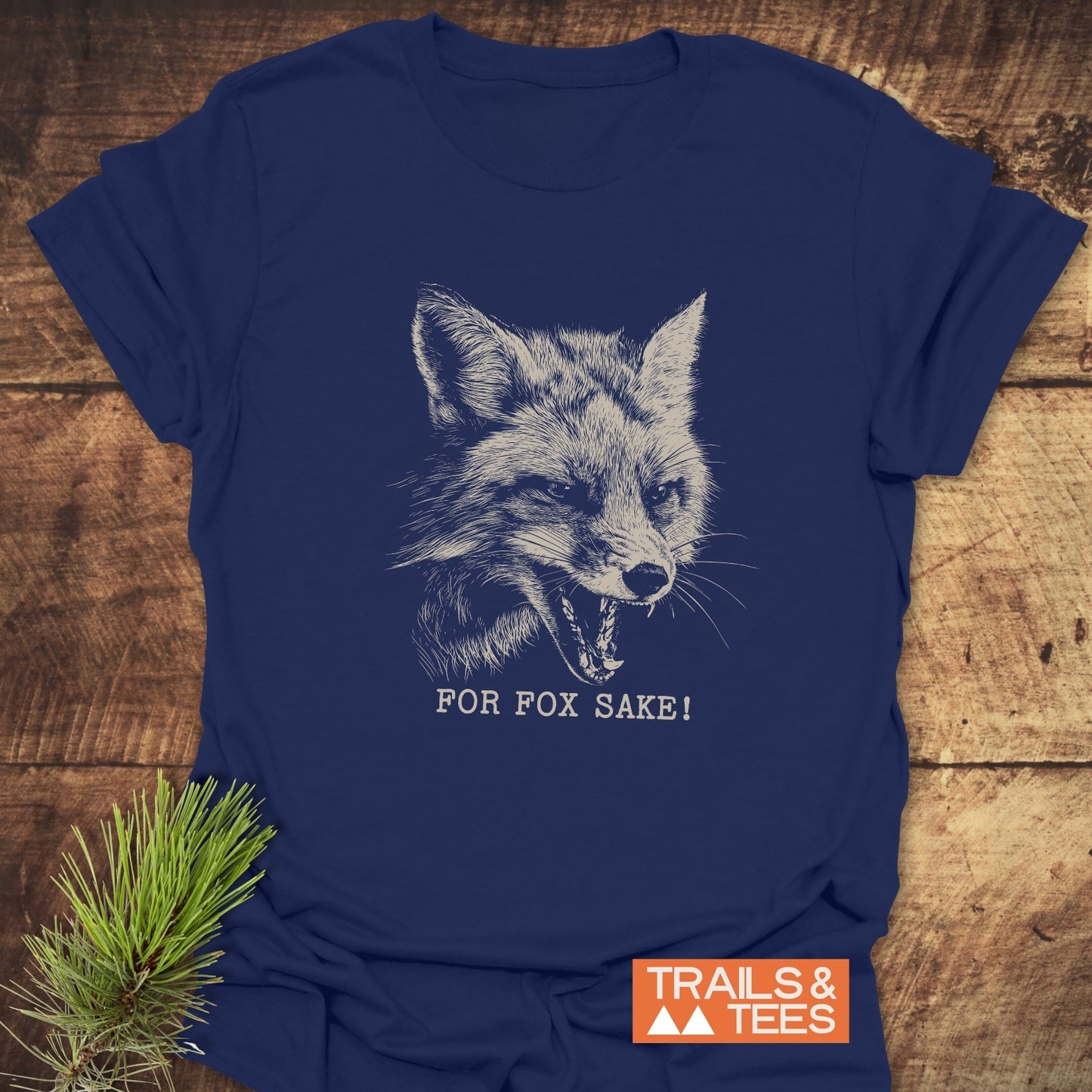 For Fox Sake! Funny T-Shirt featuring a fox sketch, crafted from soft cotton for comfort and durability, styled on a rustic wood background.