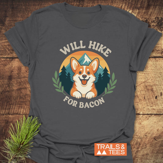 Will Hike For Bacon T-Shirt featuring a colorful corgi graphic with a sunset and mountain, showcasing comfort and durability for outdoor enthusiasts.