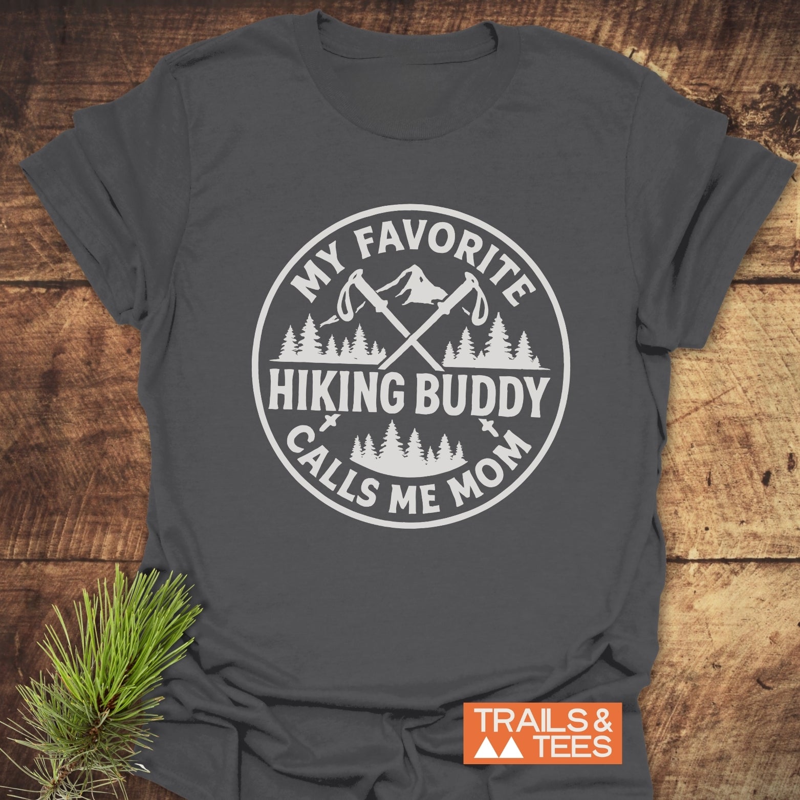 Hiking Buddy Mom T-Shirt with circular graphic of crossed hiking poles and slogan, crafted from soft ring-spun cotton for comfort and durability.