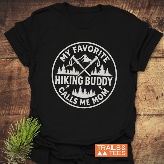 Hiking Buddy Mom T-Shirt with a circular mountain graphic and trekking poles, crafted from soft cotton for outdoor enthusiasts.