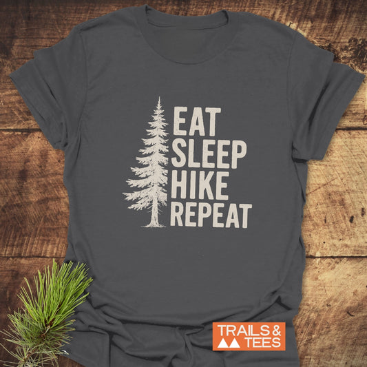 Hike, Repeat T-Shirt: dark-gray with pine tree graphic and “EAT SLEEP HIKE REPEAT” text, featuring durable print and soft, lightweight cotton for outdoor enthusiasts.