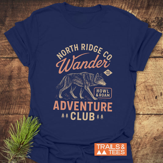 Howl And Roam Wolf T-Shirt with a stylized wolf, Adventure Club text, pine icons, and Trails & Tees logo, showcasing outdoor-inspired design.