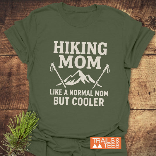 Hiking Mom T-Shirt with a mountain graphic and trekking poles, made from soft cotton for comfort. Features durable prints and a reliable fit.