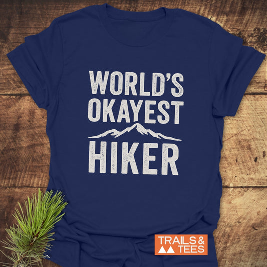 Navy-blue World's Okayest Hiker T-shirt with mountain silhouette, crafted from soft cotton for outdoor comfort, featuring durable prints and eco-friendly production.