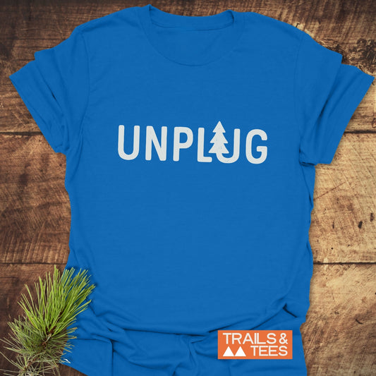 Unplug T-Shirt features UNPLUG with a tree silhouette, Trails & Tees logo, crafted from soft ring-spun cotton, ideal for outdoor enthusiasts.