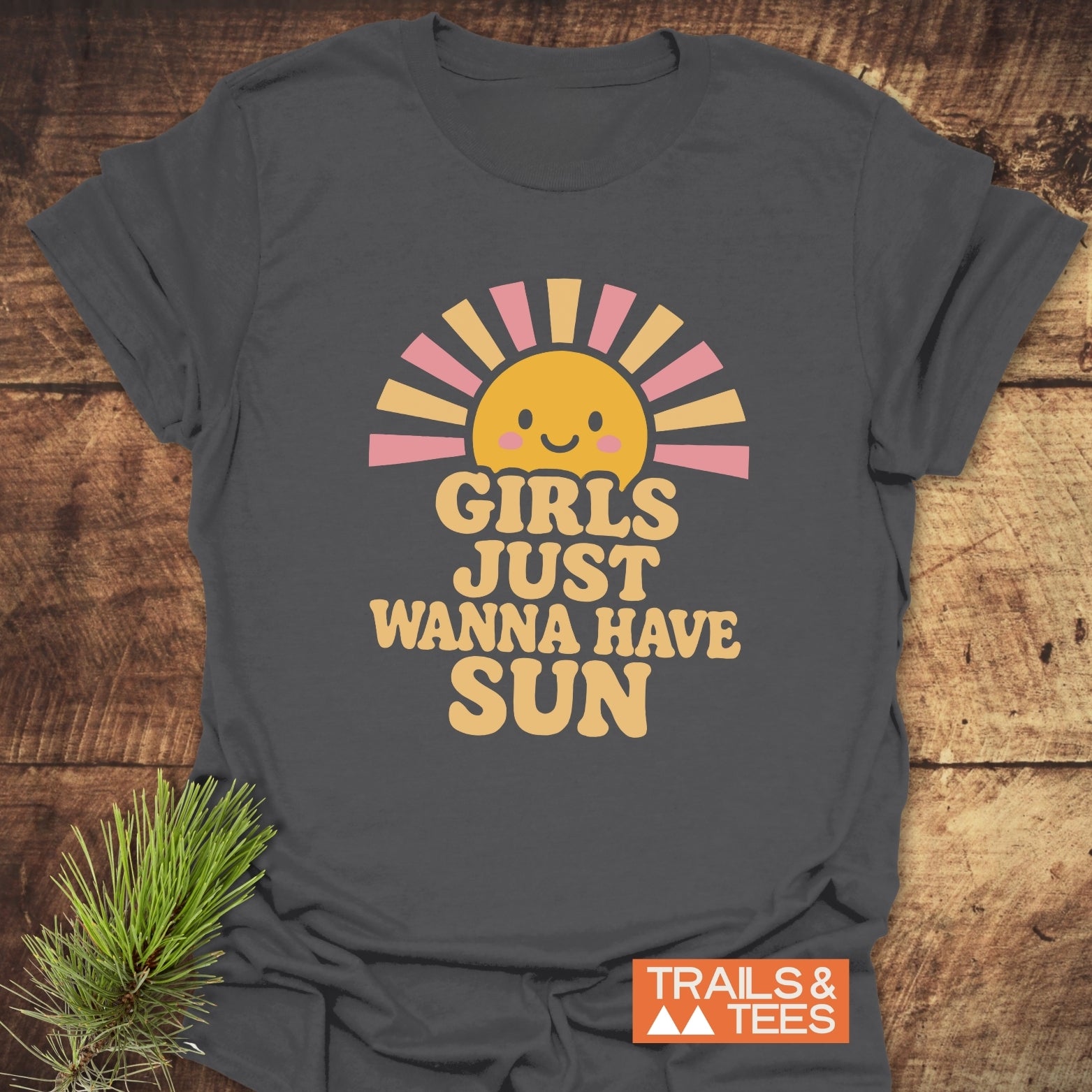 Charcoal-gray T-shirt with a smiling sun and GIRLS JUST WANNA HAVE SUN slogan. Features durable print, soft cotton, and eco-friendly production.