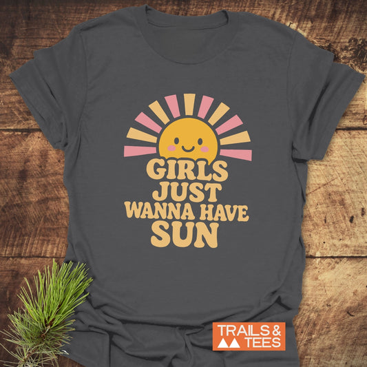 Charcoal-gray T-shirt with a smiling sun and GIRLS JUST WANNA HAVE SUN slogan. Features durable print, soft cotton, and eco-friendly production.
