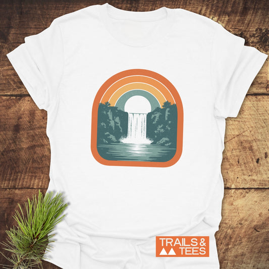 Vintage Waterfall T-Shirt featuring a retro rainbow and waterfall graphic on soft, ring-spun cotton, promising comfort and sustainable style for outdoor enthusiasts.