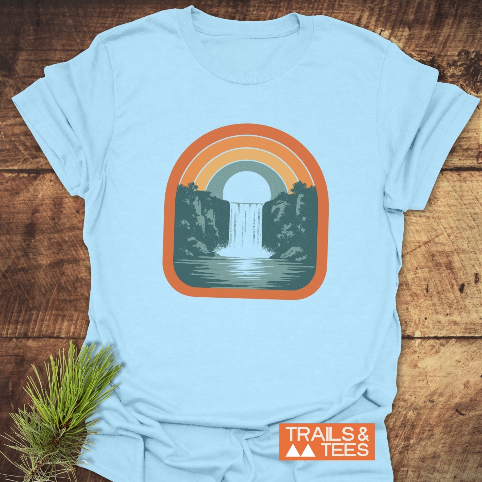 Vintage Waterfall T-Shirt featuring a retro rainbow waterfall graphic on soft, ring-spun cotton, ideal for outdoor lovers seeking comfort and style.