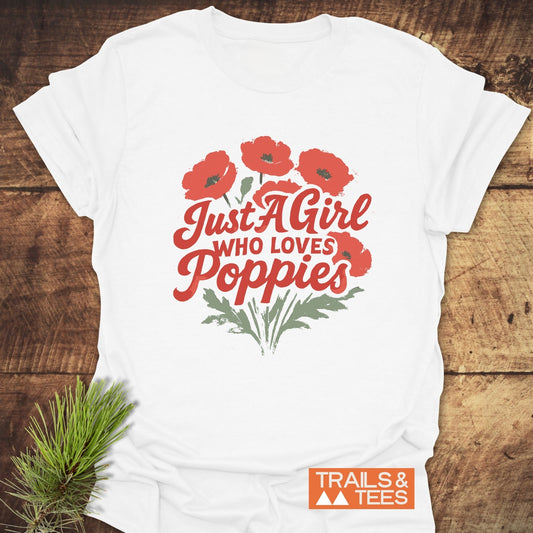 Girl Poppies T-Shirt featuring red poppy bouquet and script text. Soft, ring-spun cotton, durable print, taped shoulders for comfort. Trails & Tees logo included.
