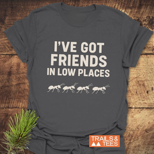 Charcoal-gray Friends In Low Places T-shirt with white text and ant silhouettes, showcasing durable, soft ring-spun cotton. Perfect for outdoor enthusiasts.