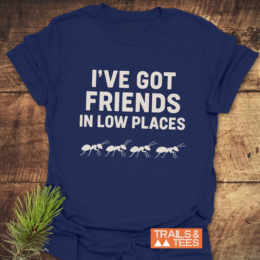 Navy-blue Friends In Low Places T-shirt with white ant silhouettes, laid flat. Soft, lightweight cotton, durable print, perfect for outdoor enthusiasts.