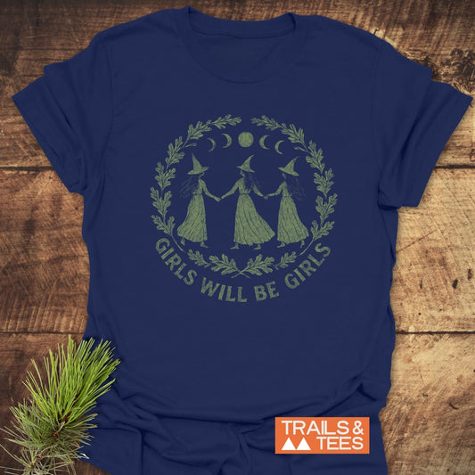 Navy blue Witches Halloween T-Shirt featuring dancing witches beneath moon phases, encircled by a wreath. Perfect for outdoor adventures, made from soft, durable cotton.