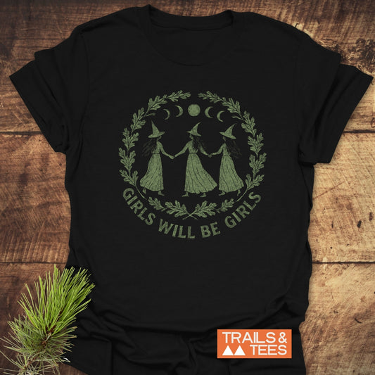 Witches Halloween T-Shirt featuring a laurel wreath and witches design, crafted from soft cotton for comfort, with durable prints, emphasizing outdoor adventure and sustainability.