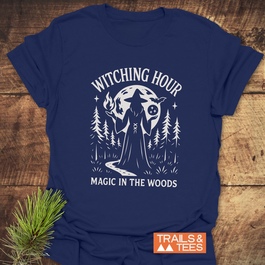 Witching Hour T-Shirt featuring a white witch graphic amidst pine trees and moon, crafted from soft ring-spun cotton for comfort and durability.
