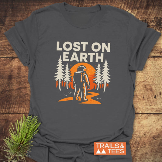 Lost On Earth T-Shirt featuring an astronaut graphic, crafted from soft cotton for comfort. Durable print, pre-shrunk fit, ideal for outdoor enthusiasts.