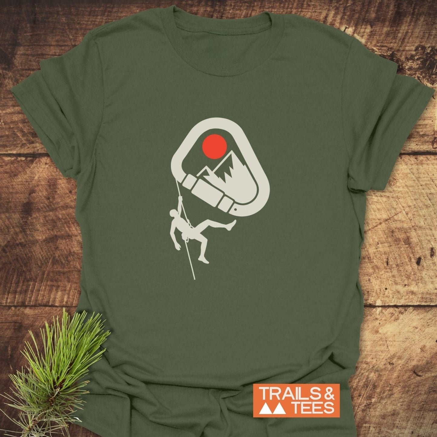 587 Mountain Climber Silhouette T-Shirt featuring a climber in a carabiner with mountain peaks and red sun, crafted from lightweight cotton for comfort and durability.