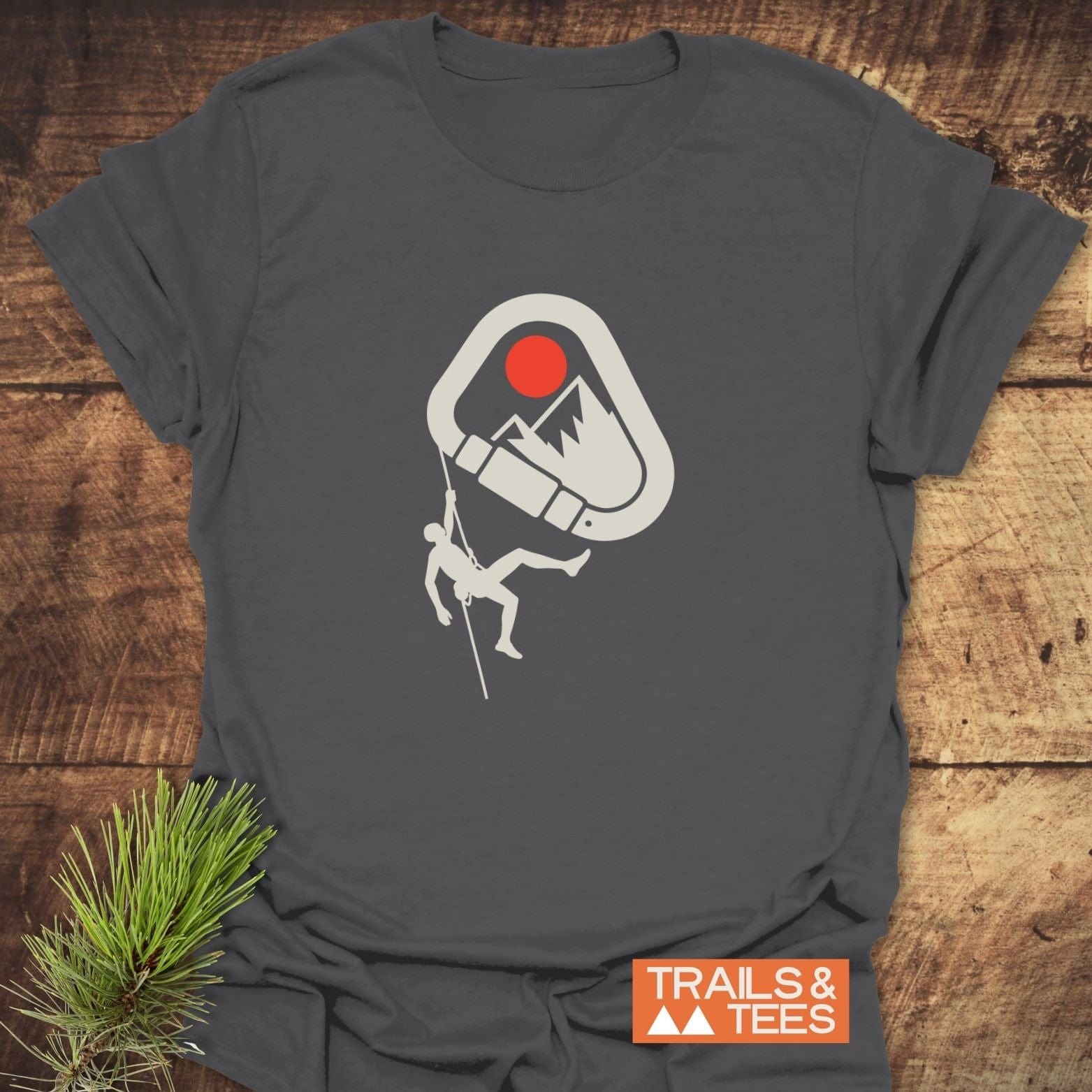 587 Mountain Climber Silhouette T-Shirt features a carabiner graphic with mountain, red sun, and climber silhouette, highlighting trail-tested comfort and durability.