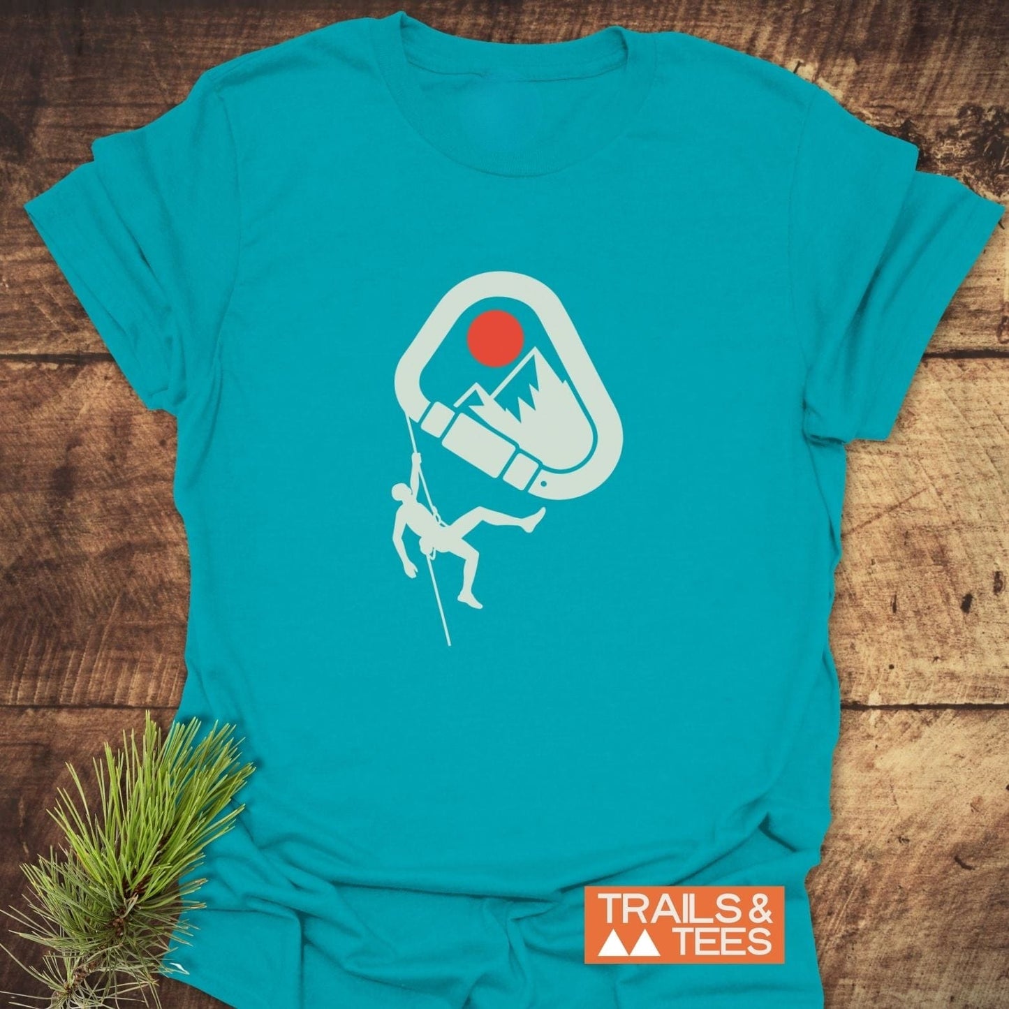 587 Mountain Climber Silhouette T-Shirt featuring a carabiner, mountain, sun graphic, and climber, laid flat, showcasing its outdoor-inspired design and durable print.