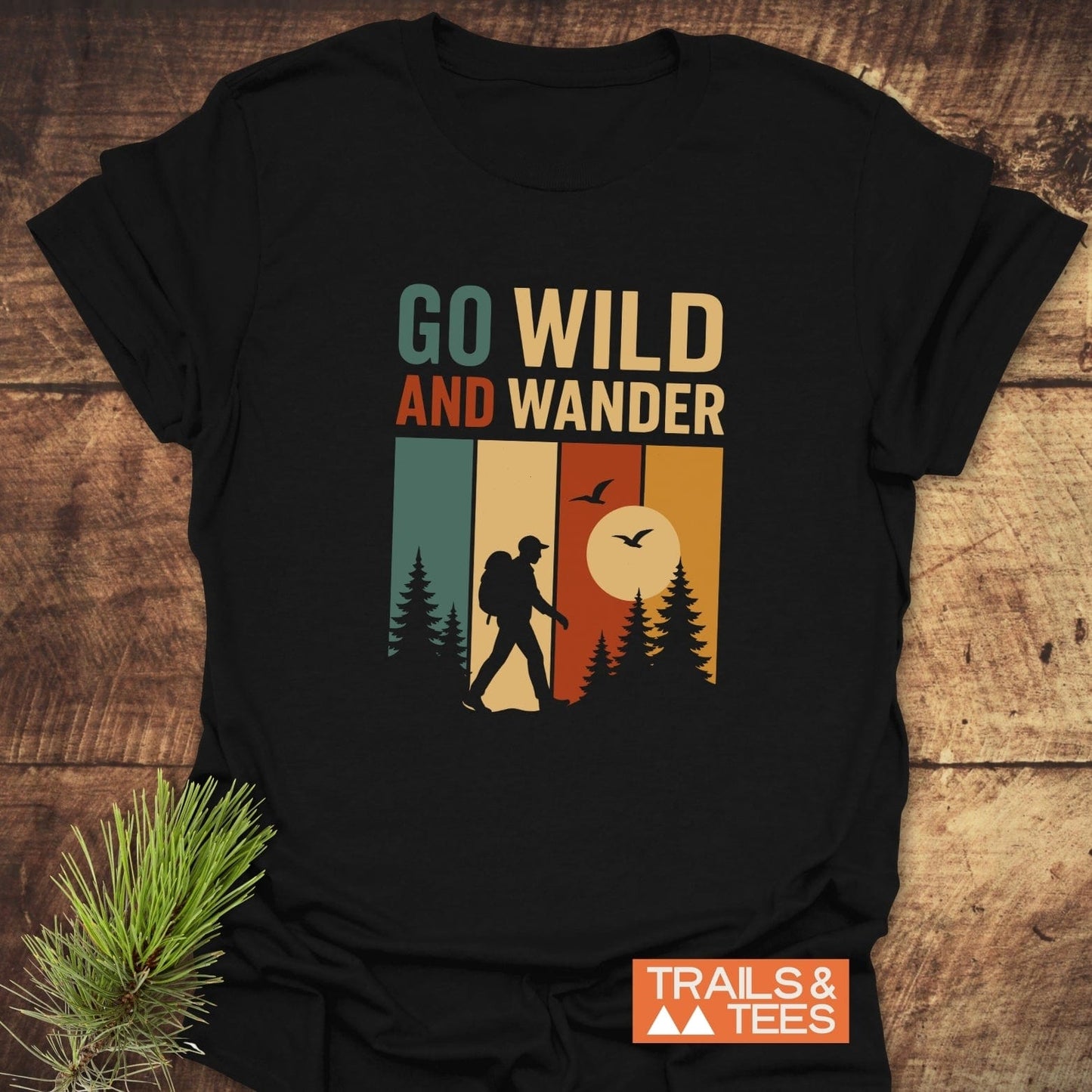 Black Go Wild T-Shirt featuring a retro graphic of a hiker among pine trees, crafted from soft cotton for durability and outdoor adventures.