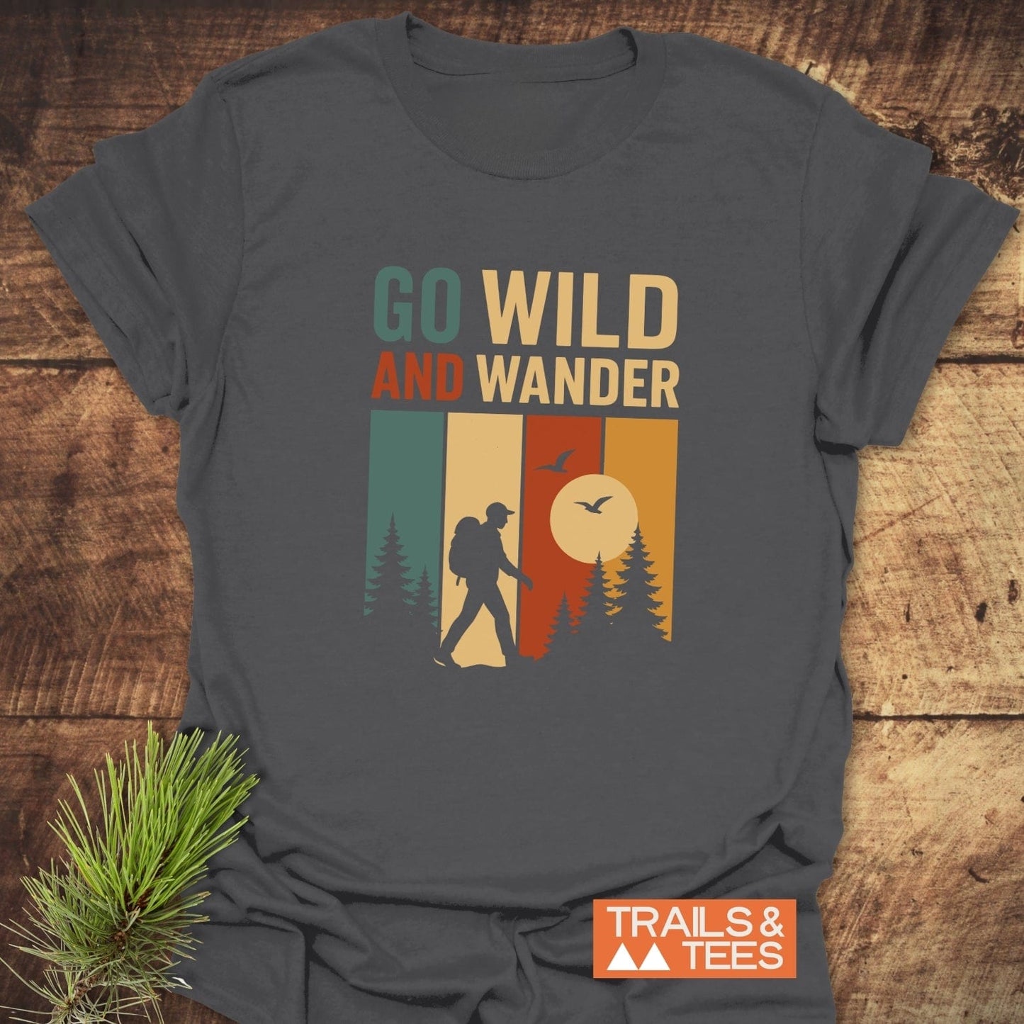 Go Wild T-Shirt featuring a hiker silhouette amidst multicolor panels, crafted from soft cotton, perfect for outdoor enthusiasts seeking comfort and style.