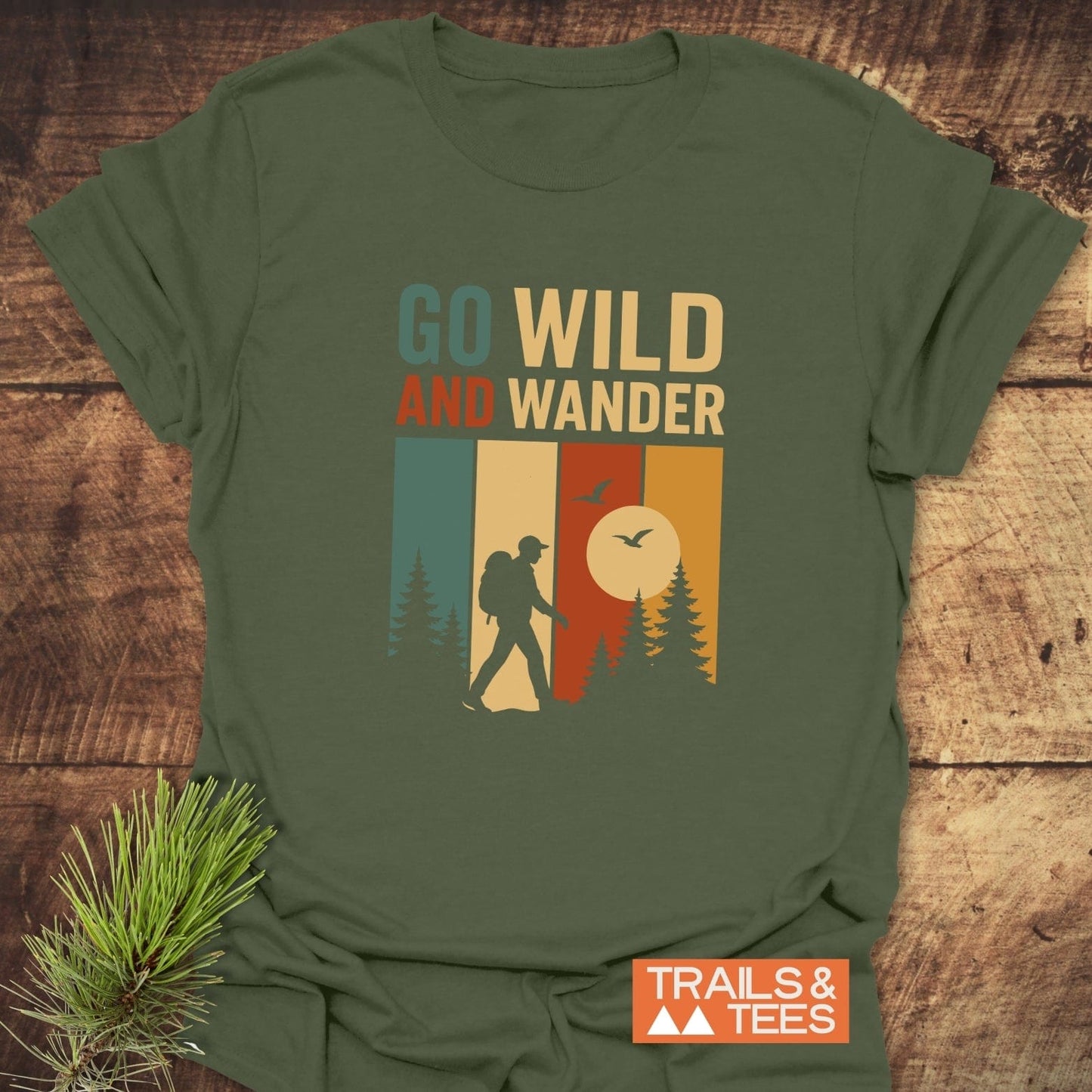Forest-green Go Wild T-Shirt with retro design featuring a hiker, evergreen trees, and slogan. Soft, ring-spun cotton for comfort and durability.