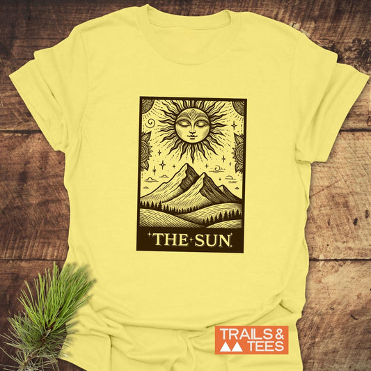 The Sun Tarot T-Shirt features a bold tarot-style sun illustration, crafted from soft ring-spun cotton for comfort and durability.
