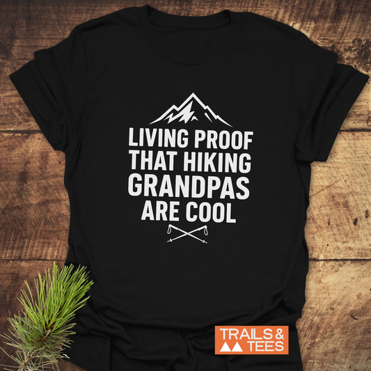Black 606 Living Proof Grandpa T-Shirt features mountain graphic, hiking poles, and bold text, ideal for hiking grandpas. Includes TRAILS & TEES logo.