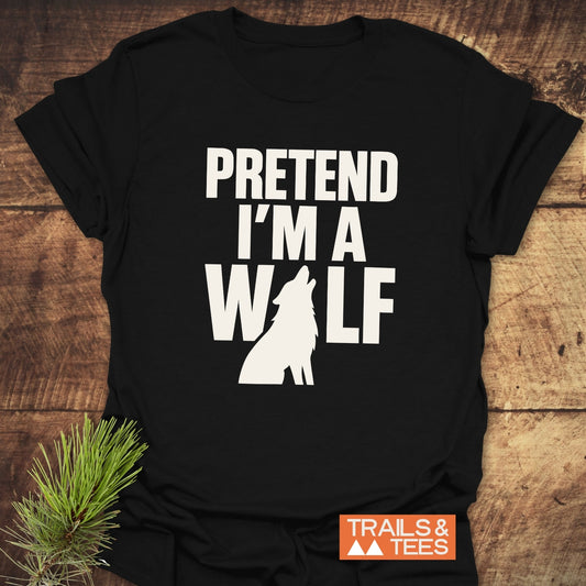 Black T-shirt with 'PRETEND I'M A WOLF' in block letters and wolf silhouette. Features 'TRAILS & TEES' logo, emphasizing outdoor adventure and comfort.