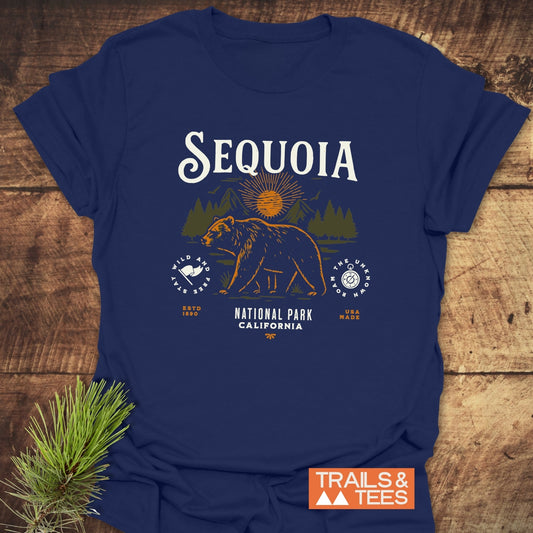 Sequoia National Park T-Shirt with vintage bear graphic, pine and mountain backdrop. Features SEQUOIA text, circular emblems, and durable, soft ring-spun cotton fabric.