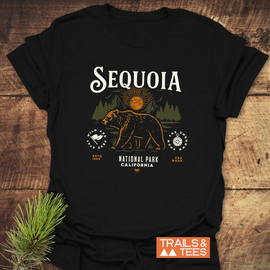 Sequoia National Park T-Shirt featuring a bear silhouette with trees and sun. Made from soft ring-spun cotton, durable print, promoting outdoor adventure.