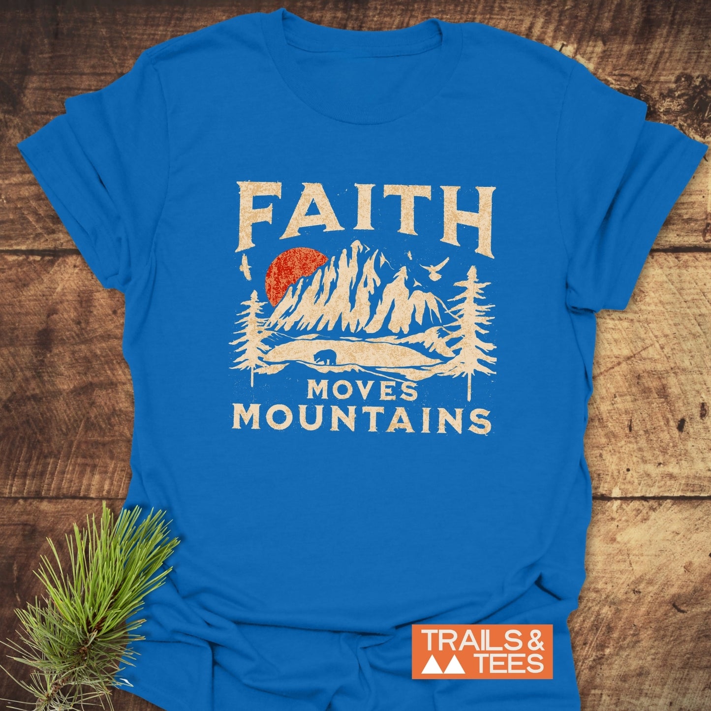 Faith Moves Mountains T-Shirt featuring a vintage mountain scene with a bear and slogan, crafted from soft cotton for comfort and durability.