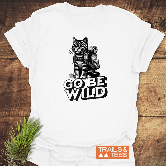 Go Be Wild Cat T-Shirt depicting a tabby cat with hiking gear and GO BE WILD print, featuring TRAILS & TEES logo.