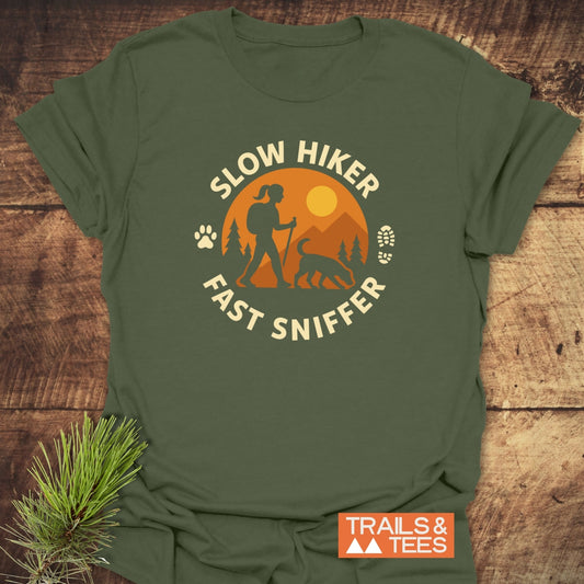 Fast Sniffer T-Shirt with a sunset mountain scene, hiker, and dog. Features durable prints, ring-spun cotton, and sustainable on-demand production.