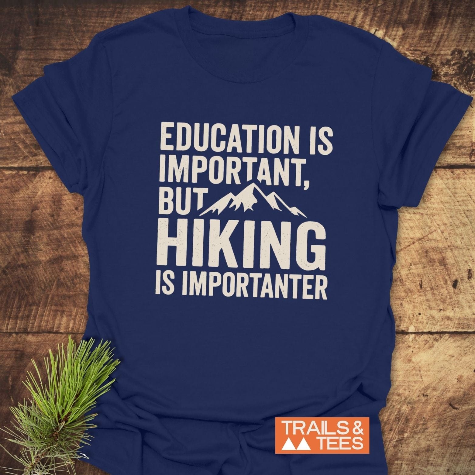 Navy-blue Education Is Important T-Shirt featuring a mountain graphic and slogan, perfect for outdoor enthusiasts. Made from soft, pre-shrunk cotton for comfort and durability.