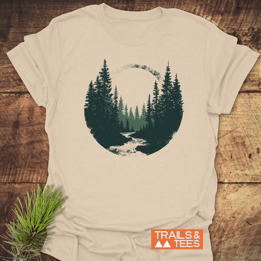 Woodland Peace T-Shirt featuring a forest scene with pine trees and stream. Lightweight, ring-spun cotton, durable print, pre-shrunk, no side seams, Trails & Tees branding.
