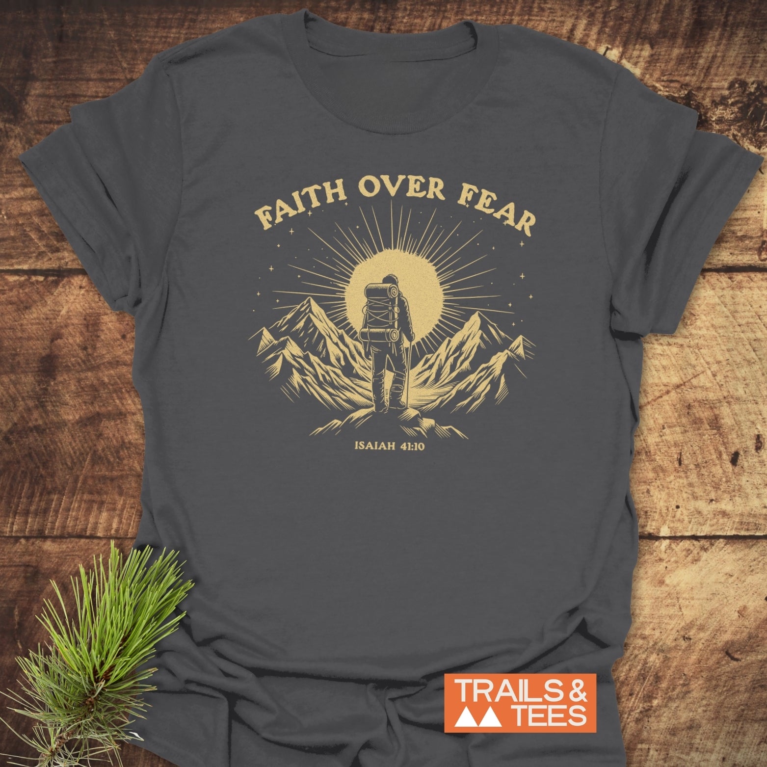 Faith Over Fear T-Shirt featuring a hiker illustration with mountains, crafted from soft cotton for outdoor adventures, pre-shrunk, durable print, promoting sustainable fashion.