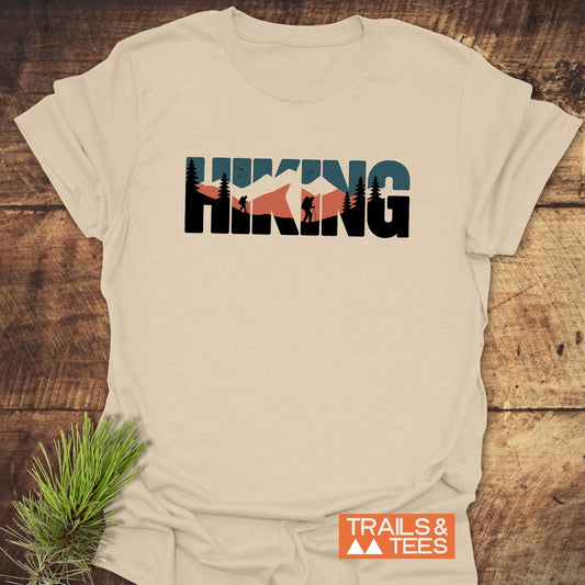 Hiking Retro T-Shirt featuring “HIKING” mountain scenes design, made from soft cotton, showcasing durable prints and brand logo, ideal for outdoor enthusiasts.