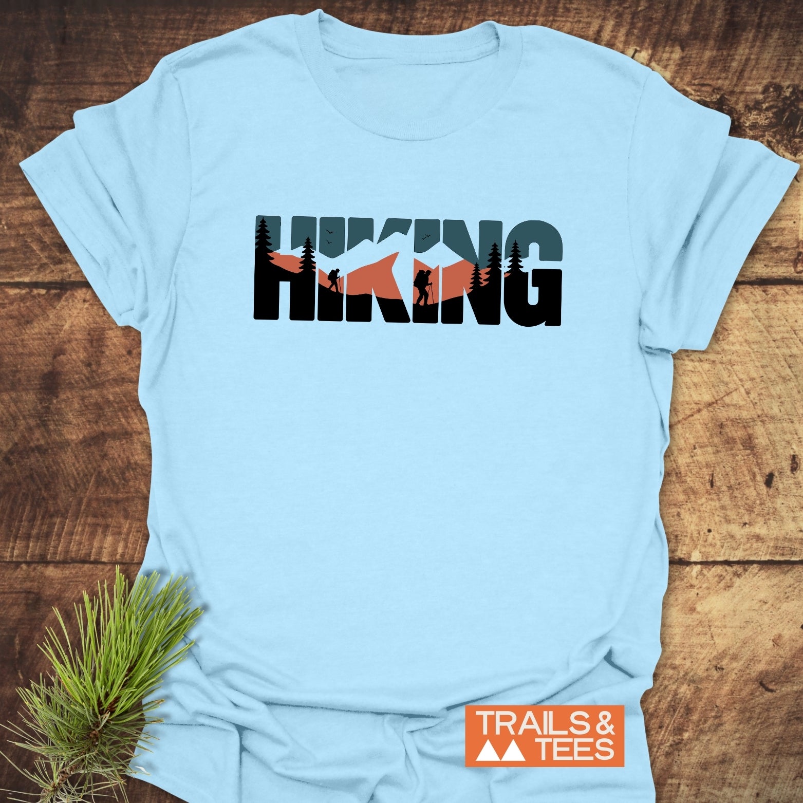 Hiking Retro T-Shirt with mountain-themed HIKING design, featuring durable prints. Includes TRAILS & TEES logo, showcasing outdoor spirit and adventure readiness.