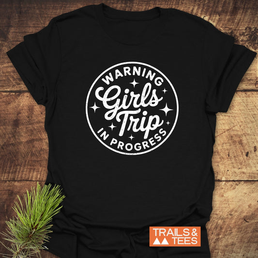 Girls Trip Hiking T-Shirt with “WARNING Girls’ Trip IN PROGRESS” graphic, crafted from lightweight ring-spun cotton for comfort, featuring durable prints and eco-conscious production.