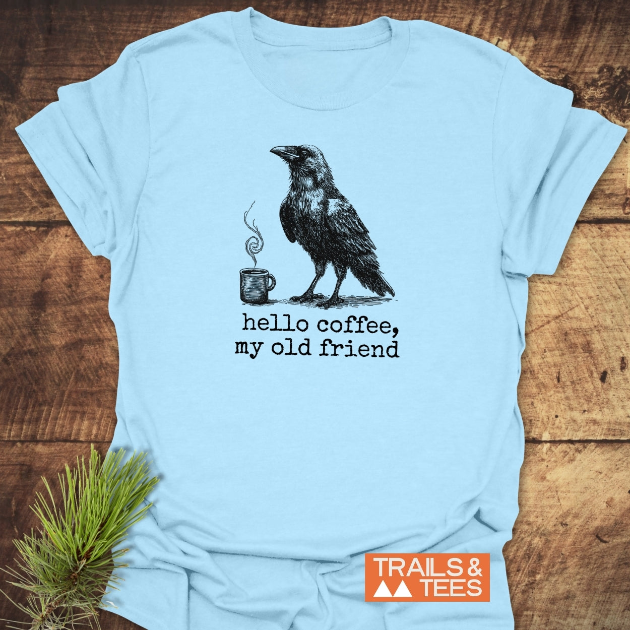 Light-blue Hello Coffee Funny T-Shirt featuring a raven and coffee mug graphic, made from soft cotton, ideal for outdoor enthusiasts.