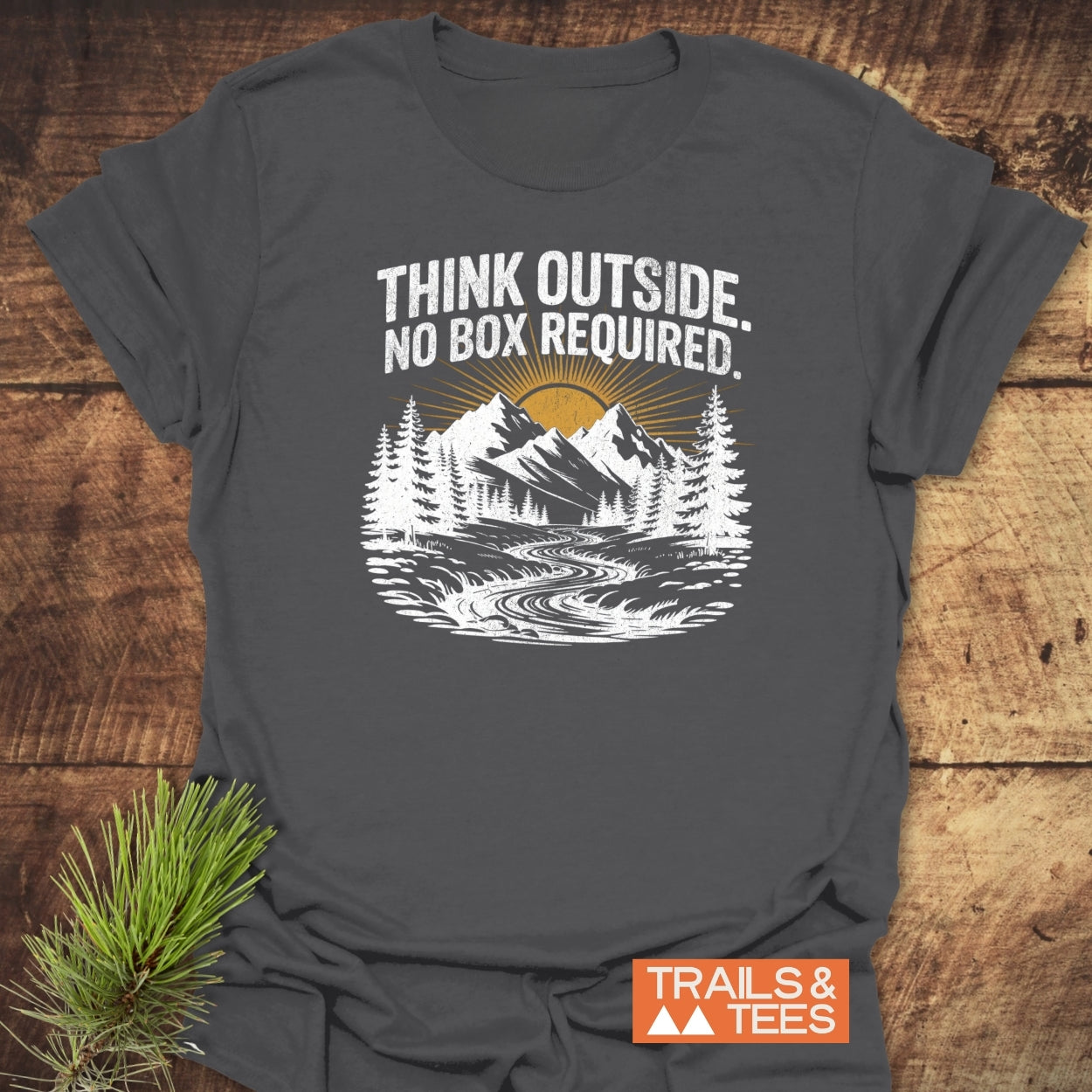Think Outside T-Shirt with mountain graphic and slogan. Features durable, soft cotton for outdoor enthusiasts, emphasizing comfort and sustainability.