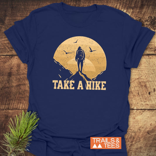 Take A Hike T-Shirt featuring a hiker graphic under a distressed sun with birds, designed for comfort and adventure with durable prints and pre-shrunk fit.