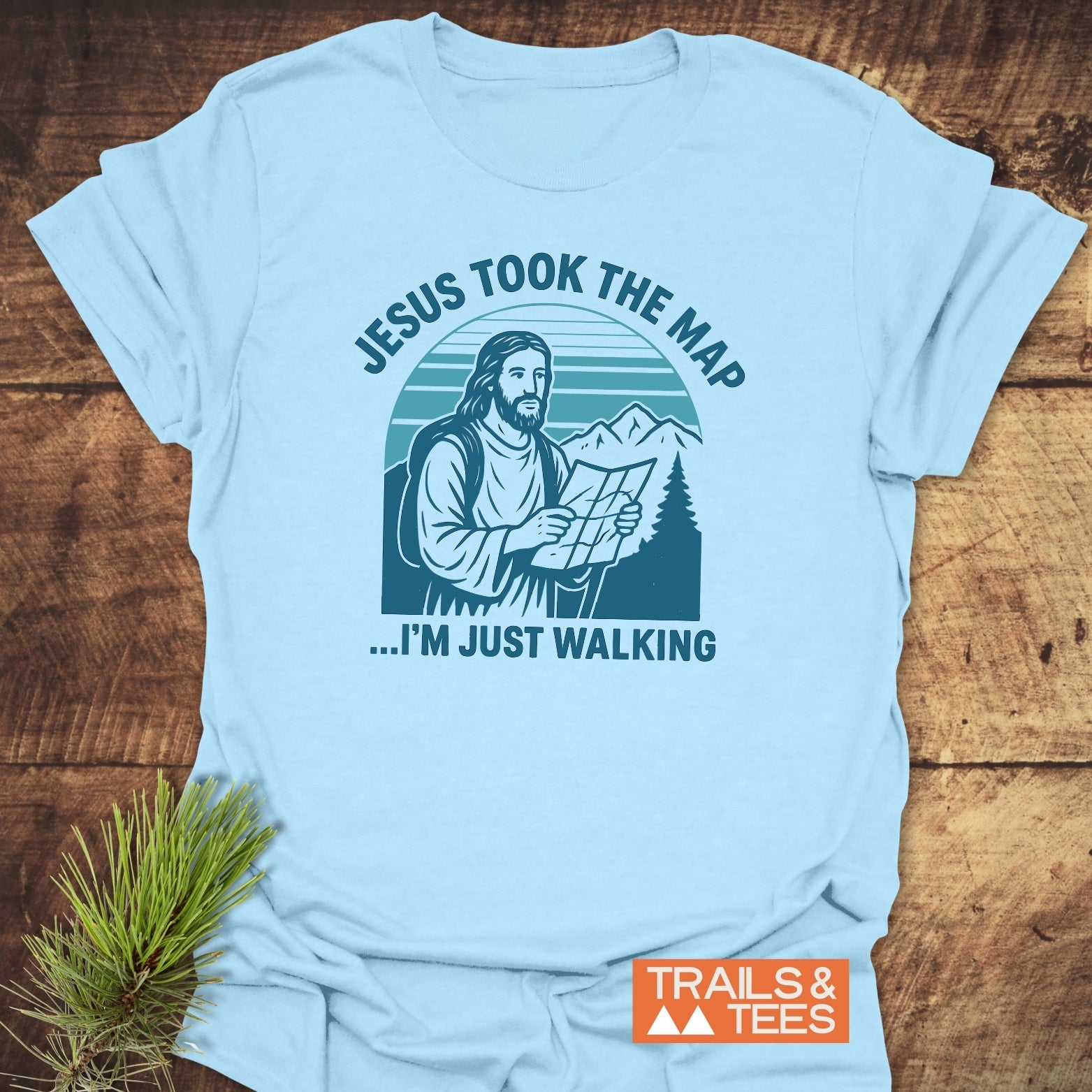 Jesus Took The Map T-Shirt featuring Jesus with a map, surrounded by mountains, emphasizing comfort and durability with pre-shrunk, ring-spun cotton and long-lasting prints.