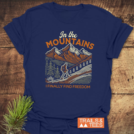 Mountain Freedom T-Shirt featuring a stylized mountain scene and hiker graphic, crafted from soft, lightweight cotton for comfort and adventure.