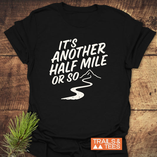 Half Mile Funny T-Shirt featuring a mountain path graphic and slogan. Made from soft cotton for outdoor comfort, with durable prints and a reliable fit.