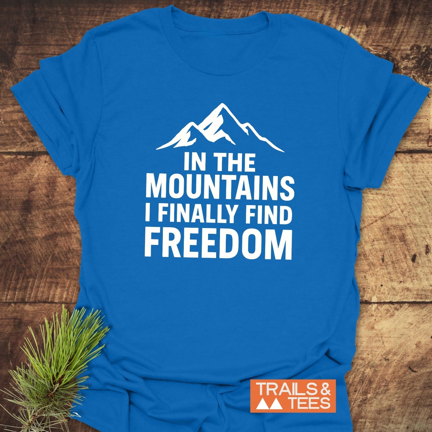 Finally Freedom T-Shirt with white mountain graphic and text. Made from soft ring-spun cotton, featuring durable prints, perfect for outdoor adventures.